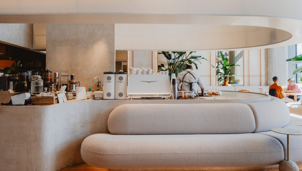 Interiér Mondieu s bielym kávovarom Nuova Simonelli Eagle One.